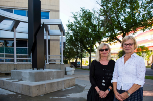 Janine Andrews (left), executive director of University of Alberta Museums, and Cornelia Morcos stand in front of Signalos III by sculptor Kosso Eloul.
